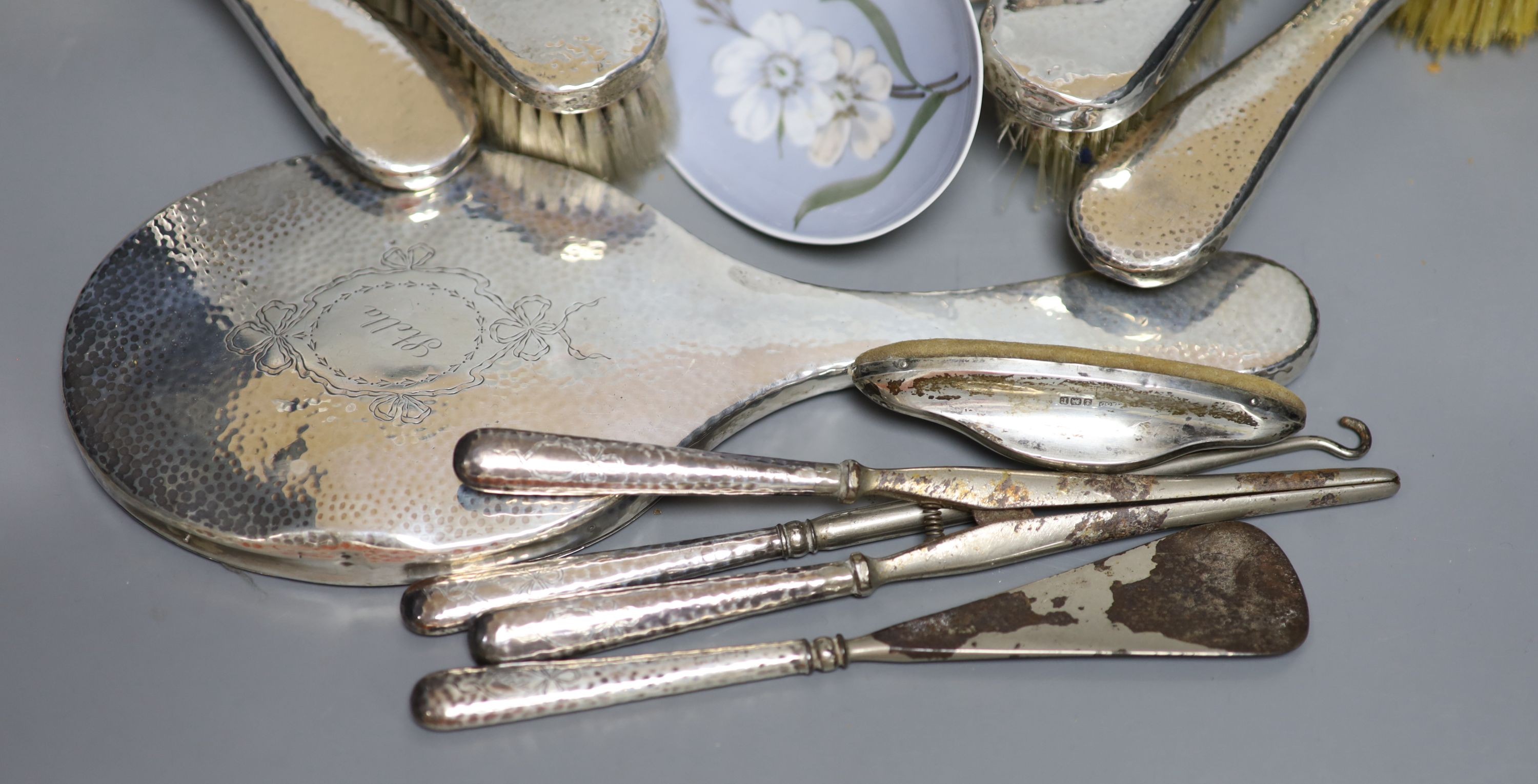 A George V hammered silver ten piece dressing table set with tray, engraved 'Stella' and six other items including a silver circular powder box?, a tortoiseshell mounted trinket box and two plate goblets.